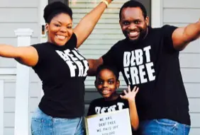Photo of Seannie and her family wearing t-shirts that say "Debt Free" on them