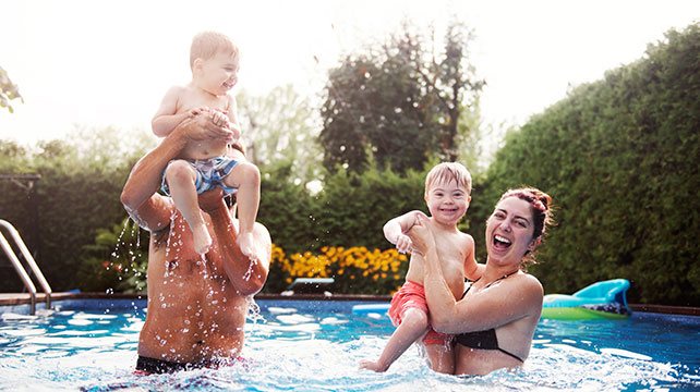family laughing in a swimming pool
