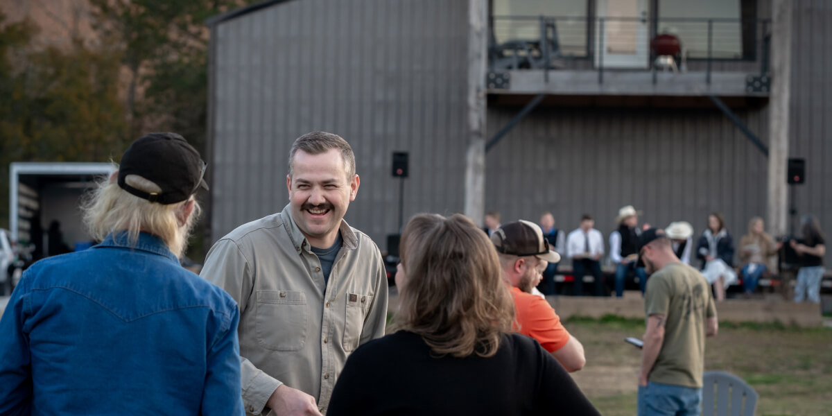 Andy Baker outside with team members, smiling
