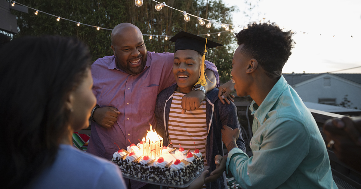 family celebrates teen grad with cake