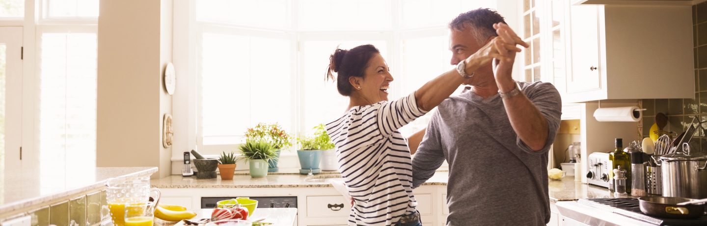 A couple dancing in their kitchen.