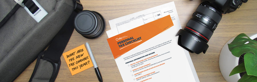A tax prep checklist and other office supplies are on a desk.