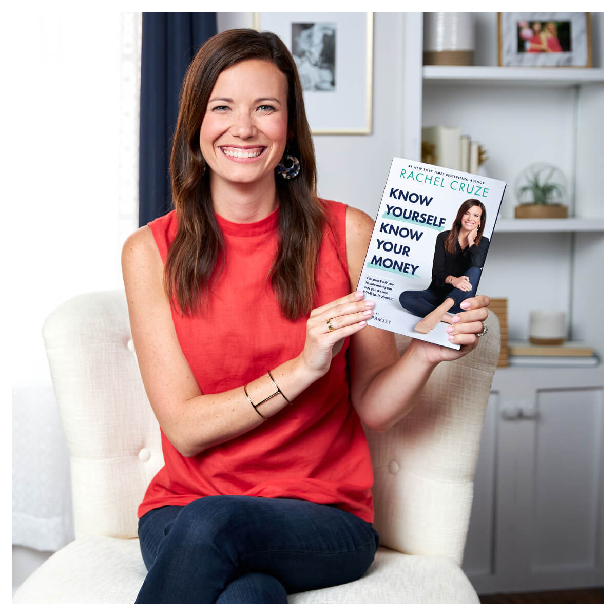 Rachel Cruze holding her book "Know Yourself Know Your Money"