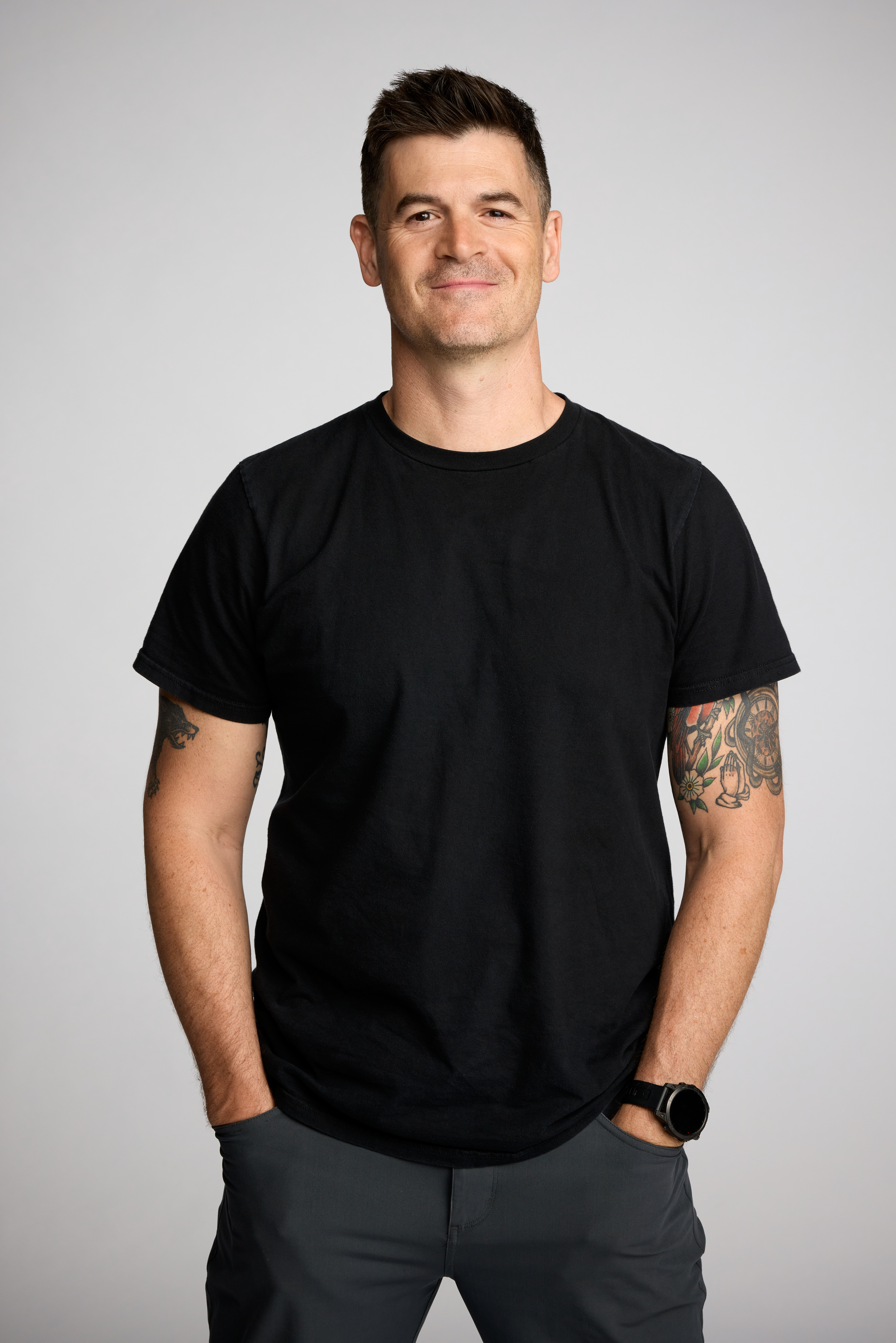 portrait of Dr. John Delony in a black t-shirt