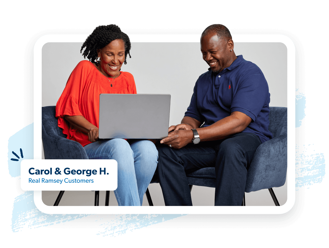 Image of a couple sitting looking at their laptop