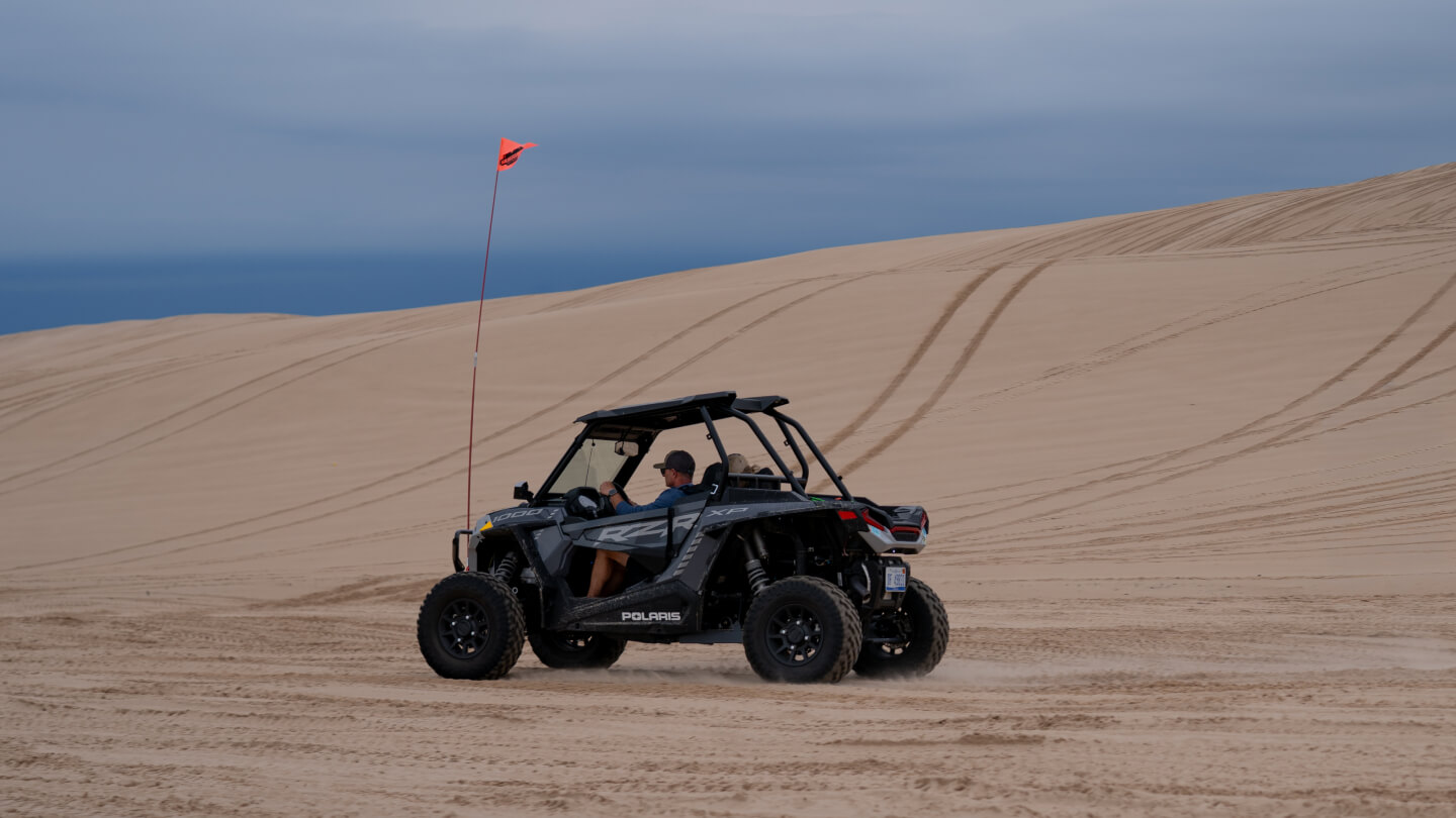 Aaron Baeder on vacation in dune buggy.