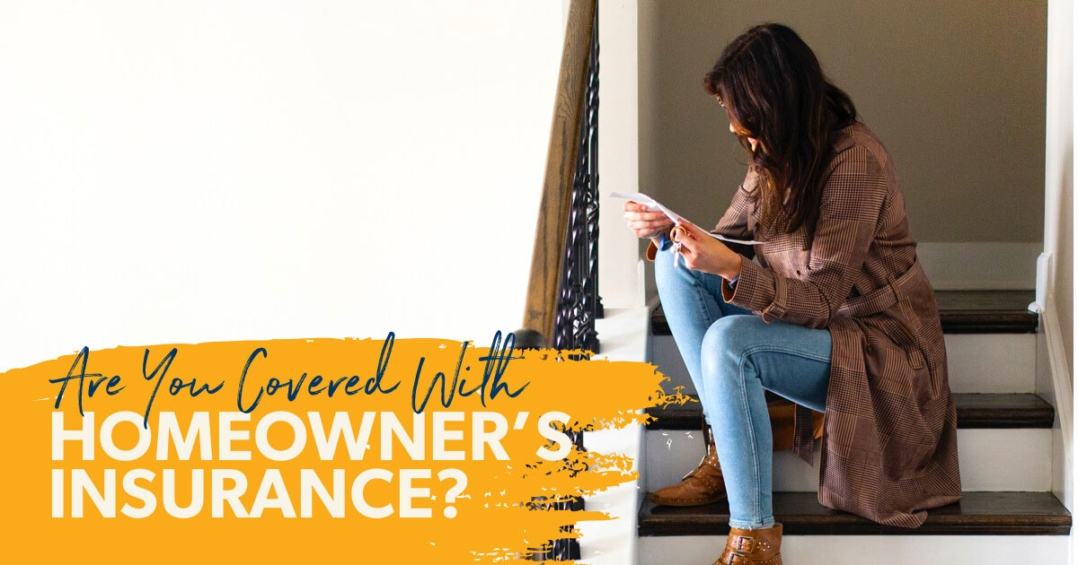 A woman sitting on her stairs reading about what is protected and what is not protected by her home insurance.