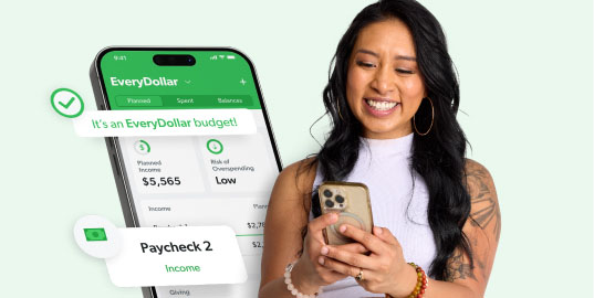Woman using her phone to budget on the EveryDollar mobile app