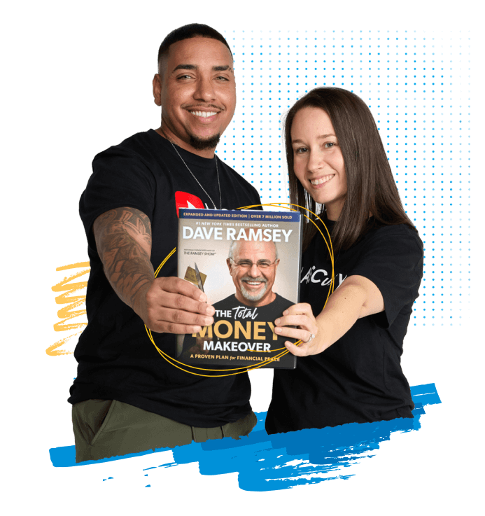 A couple holding a copy of The Total Money Makeover by Dave Ramsey